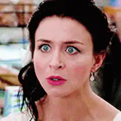 Woman with wide blue eyes staring