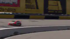 Red rally car drifting on track