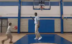 Man and child playing basketball