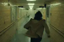 woman running down a hospital corridor