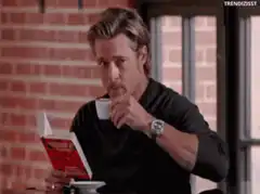 Brad Pitt drinking coffee while reading