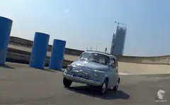Light blue Fiat 500 driving on rooftop