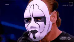 Sting removes his wrestling mask