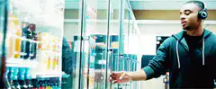 Man grabs iced tea from fridge