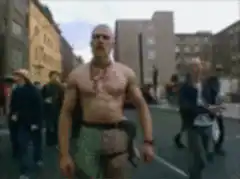 Shirtless man gets water poured on him