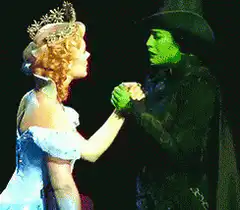 Elphaba and Glinda hold hands then hug