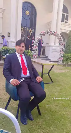 Man in suit sitting outside wedding venue