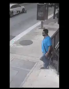 Man leans on fence then walks away