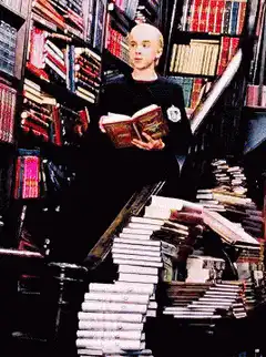 Draco Malfoy reading a book