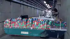 Man in silver suit driving Evergreen container ship