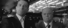 Two men in suits looking serious