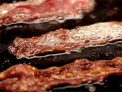 bacon sizzling in a pan