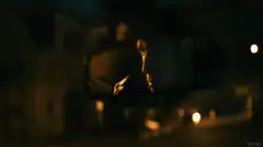 Man in rearview mirror at night