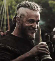 Ragnar Lothbrok smiling with a mug