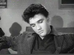 Elvis Presley looking down then up