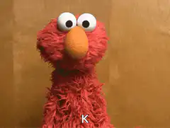 Elmo shrugs with letter K