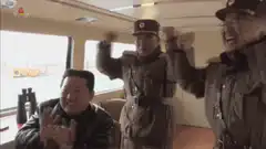 Kim Jong Un and officers cheering