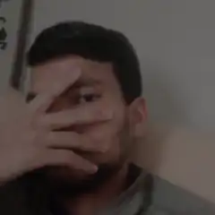 man covering face with hand