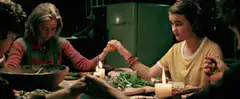 The Craft girls holding hands at dinner