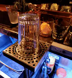 finger tapping crystal glass on bar