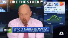 Bald man nodding during Gamestop stock report