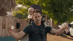 Mark Ruffalo throws playing cards with baby on back