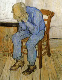 Old Man Sitting in Chair Head in Hands