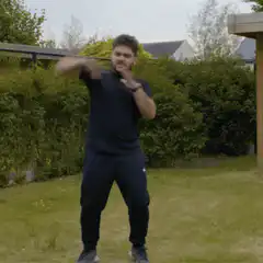 Man doing martial arts moves in garden