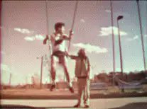 Man swinging high on a swing set