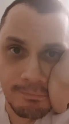 Man resting cheek on hand