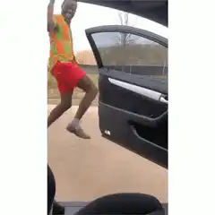 Man dancing next to car door