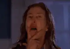 Woman screaming with hand over mouth