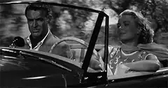 Cary Grant and Grace Kelly in a convertible