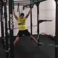 Man doing pull-ups with legs tied