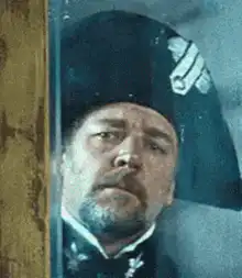 Russell Crowe as Maximus peeking through window