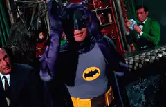 Batman adjusts his cowl