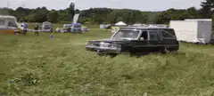 black hearse drifting in grass