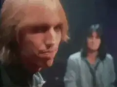 Tom Petty nodding with drummer in background