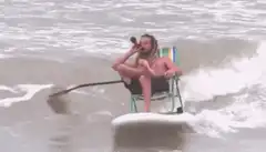 man smoking pipe on surfboard chair