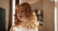 girl flips curly red hair