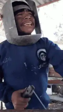 Man drinking beer with welding mask