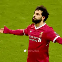 Mohamed Salah celebrating with arms out