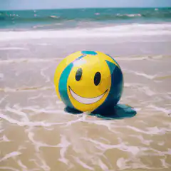 Smiley beach ball on the shore