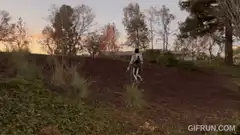 person running up a hill at sunset