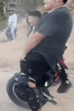 Two men riding small motorbikes on dirt