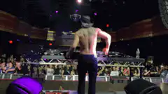 Shirtless man dancing on stage