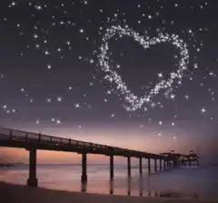 Sparkling heart in the night sky over a pier