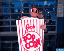 Jimmy Fallon eating popcorn with 3D glasses