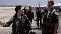 Maverick and Goose high five on tarmac