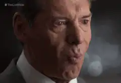 Vince McMahon blowing a kiss and pointing